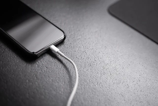 Smartphone connected to a charging cable